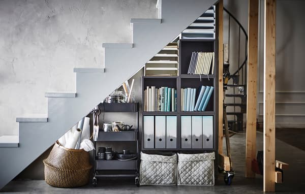 A storage under the stairs with KALLAX and a RASKOG trolley.