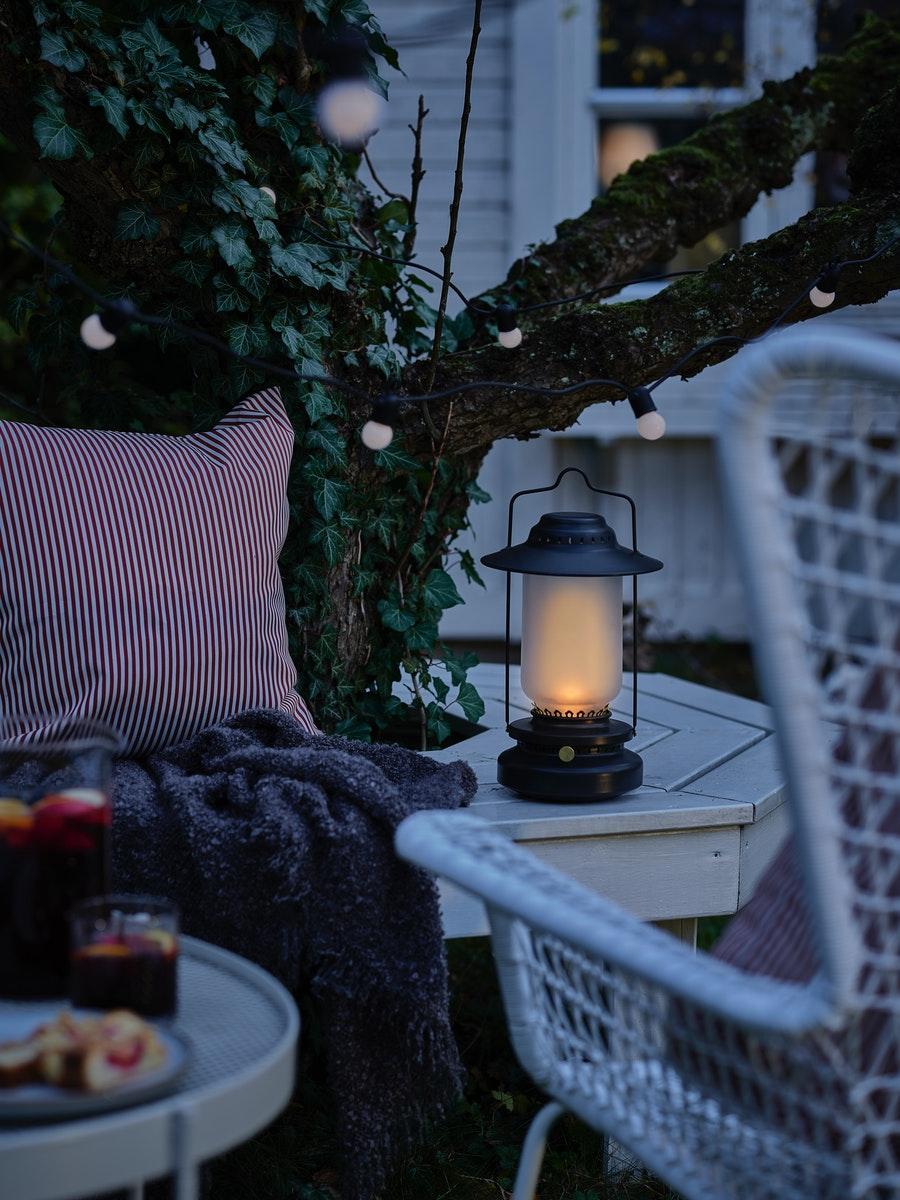 A STORHAGA LED lamp standing on a bench. 