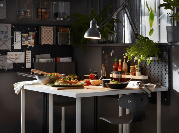 A study space converted back to a dining area, with an IKEA LINNMON white table and MOLTE dark grey swivel chairs. 