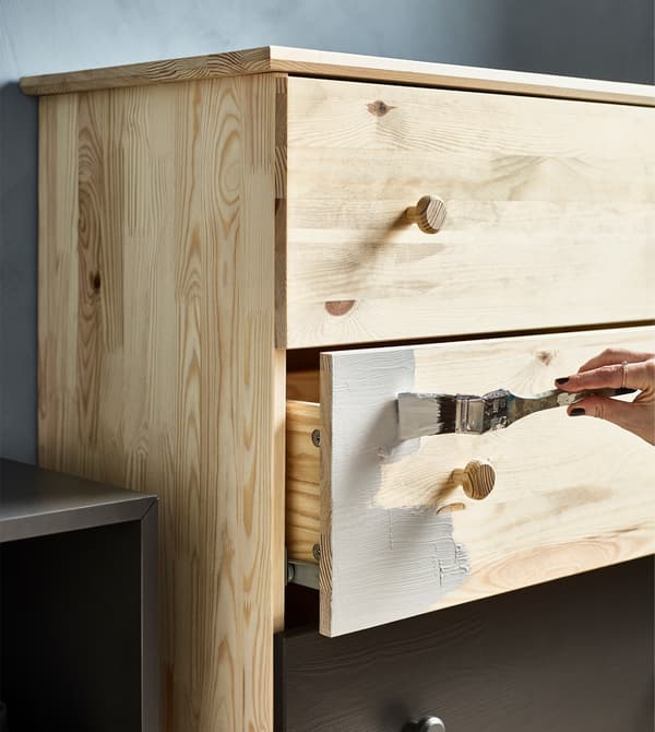 A TARVA chest of drawers being painted a different colour to show who owns it in a shared home.