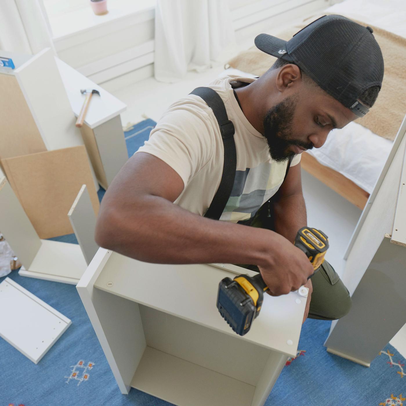 A Task Rabbit tasker assembling an IKEA piece of furniture.