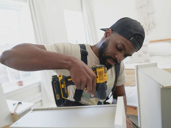 A Taskrabbit Tasker assembling an IKEA cabinet.