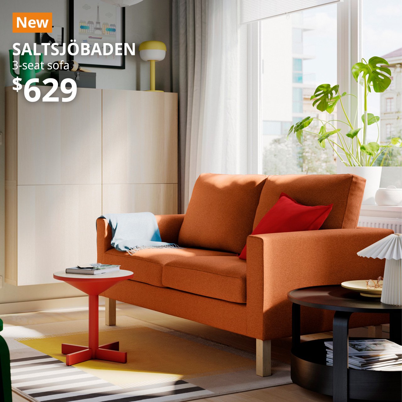 A tonerud red-brown 3-seat SALTSJÖBADEN sofa in a living room seating. An orange "NEW" label is on the top left of the image with white text that reads: SALTSJÖBADEN, 3-seat sofa, $629.