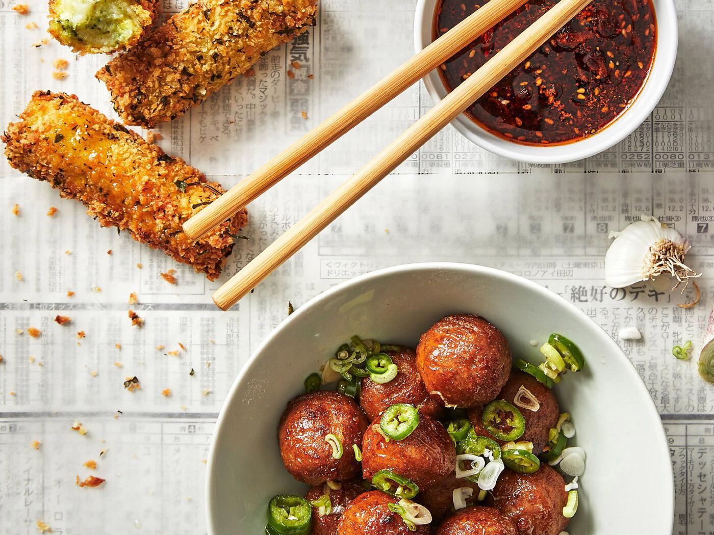 A top angled shot of the table with plates of plant balls and crispy vegetbale croquettes