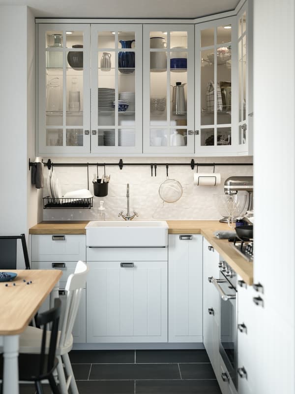 A traditional-style white STENSUND kitchen with wooden worktop and a white Belfast sink