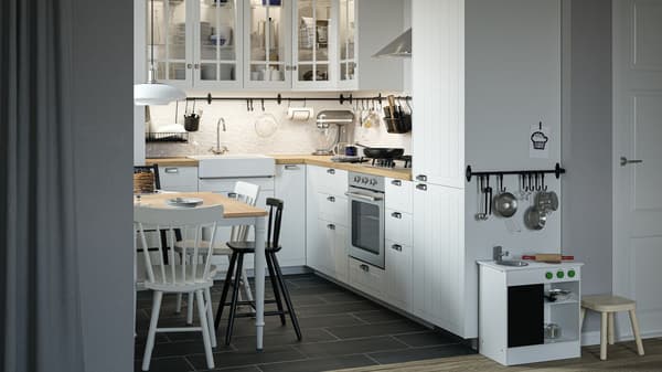 A traditional-style white STENSUND kitchen with wooden worktop and a white Belfast sink