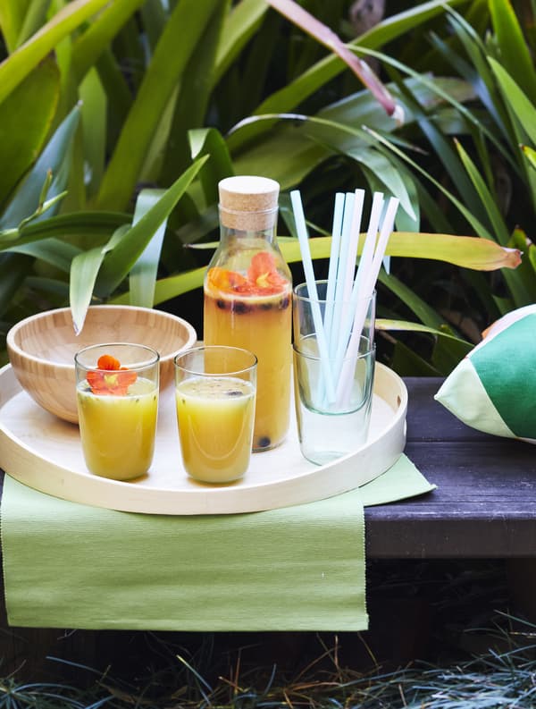 A tray carrying juice and glasses.