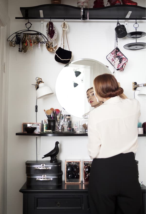 A vanity area with mirror and lighting. 
