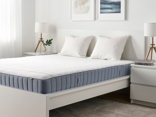 A view of a bedroom with a mattress.