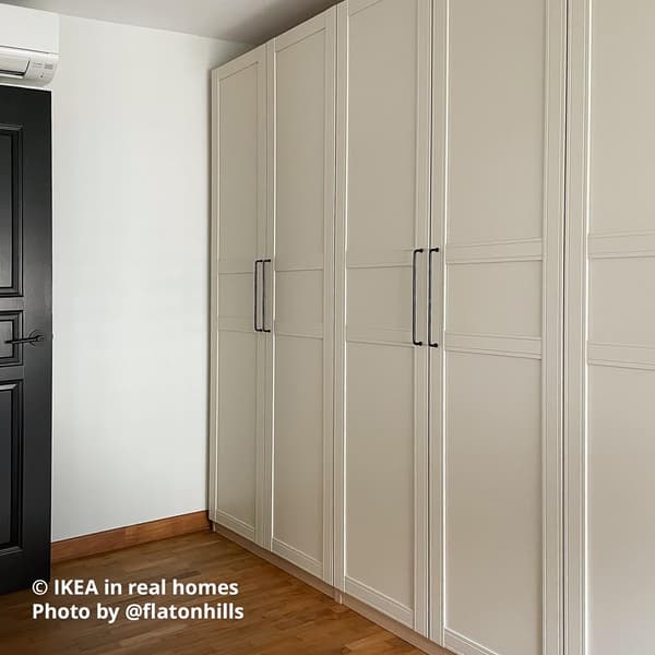 A walk-in wardrobe with beige coloured PAX wardrobe combination. IKEA in real homes Photo by @flatonhills.
