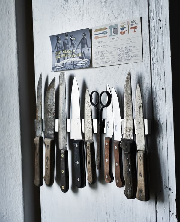 A wall display of a kitchen knife collection.