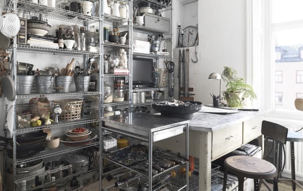 A wall of metal open storage in a kitchen.