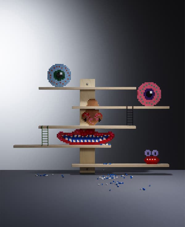 A wall shelf decorated with a face.