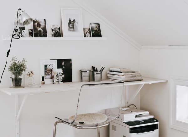 A wall shelf which has been converted into a desk.