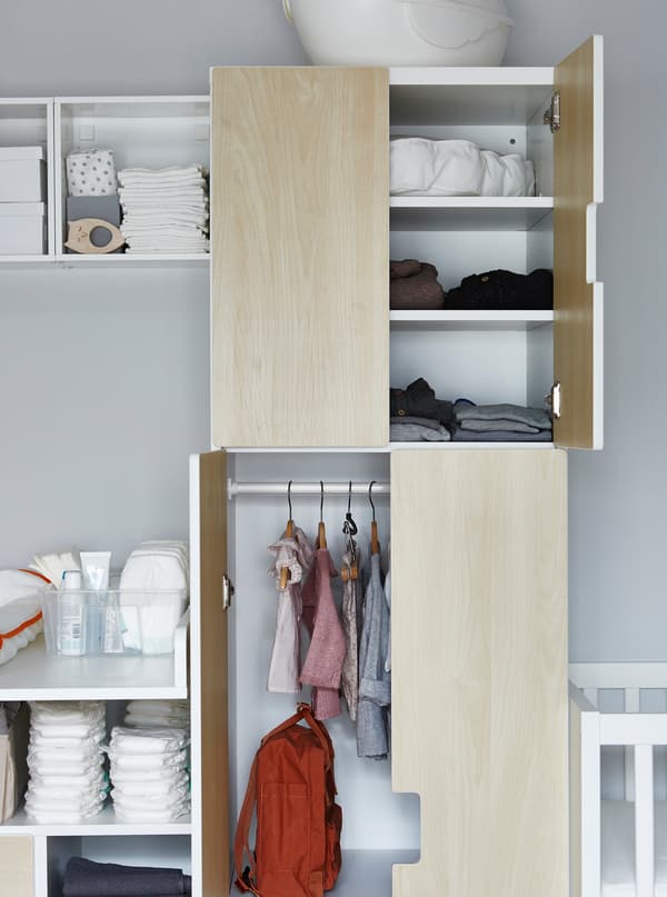 A wardrobe with hanging space for babies clothes.
