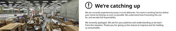 A warehouse with furniture boxes and a notice: 
