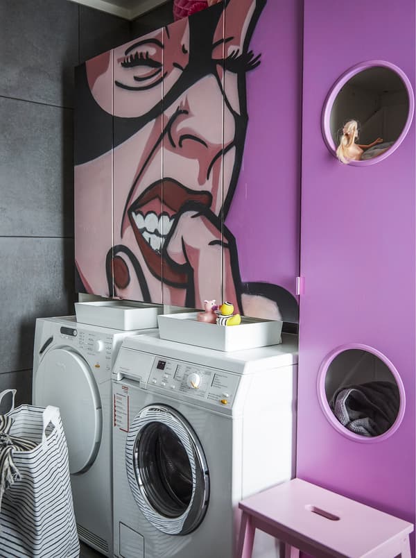 A washroom with pink graffitied wall.