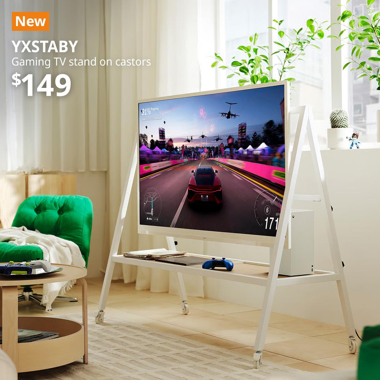 A well-lit living room setting lifestyle shot featuring a white YXSTABY gaming tv stand on castors with a white framed TV and XBOX placed on it. An orange "NEW" label is displayed in the top left corner of the image, featuring black text that reads: "YXSTABY, Gaming tv stand on castors, $149"