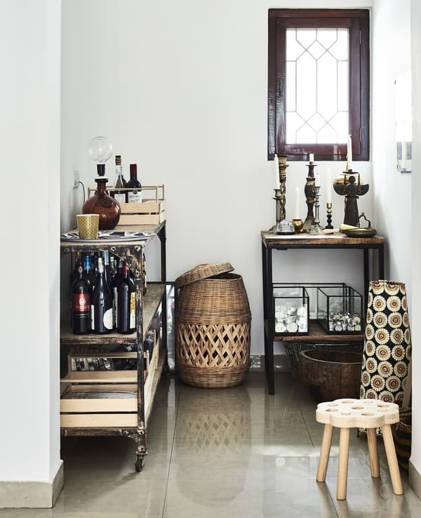 A wheeled trolley and side table in an alcove.