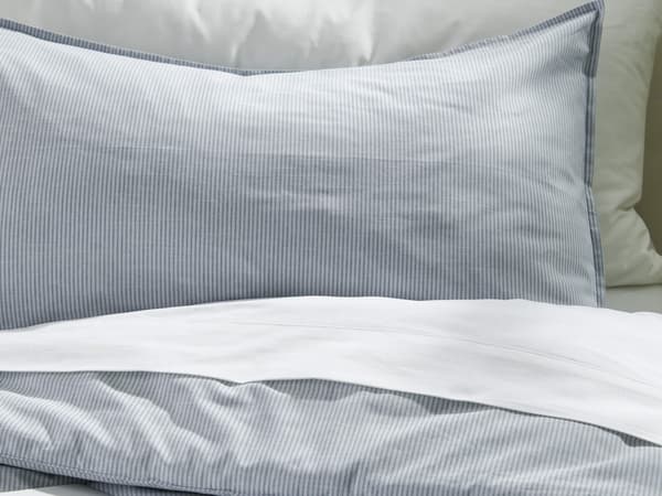 A white and blue striped bedding.