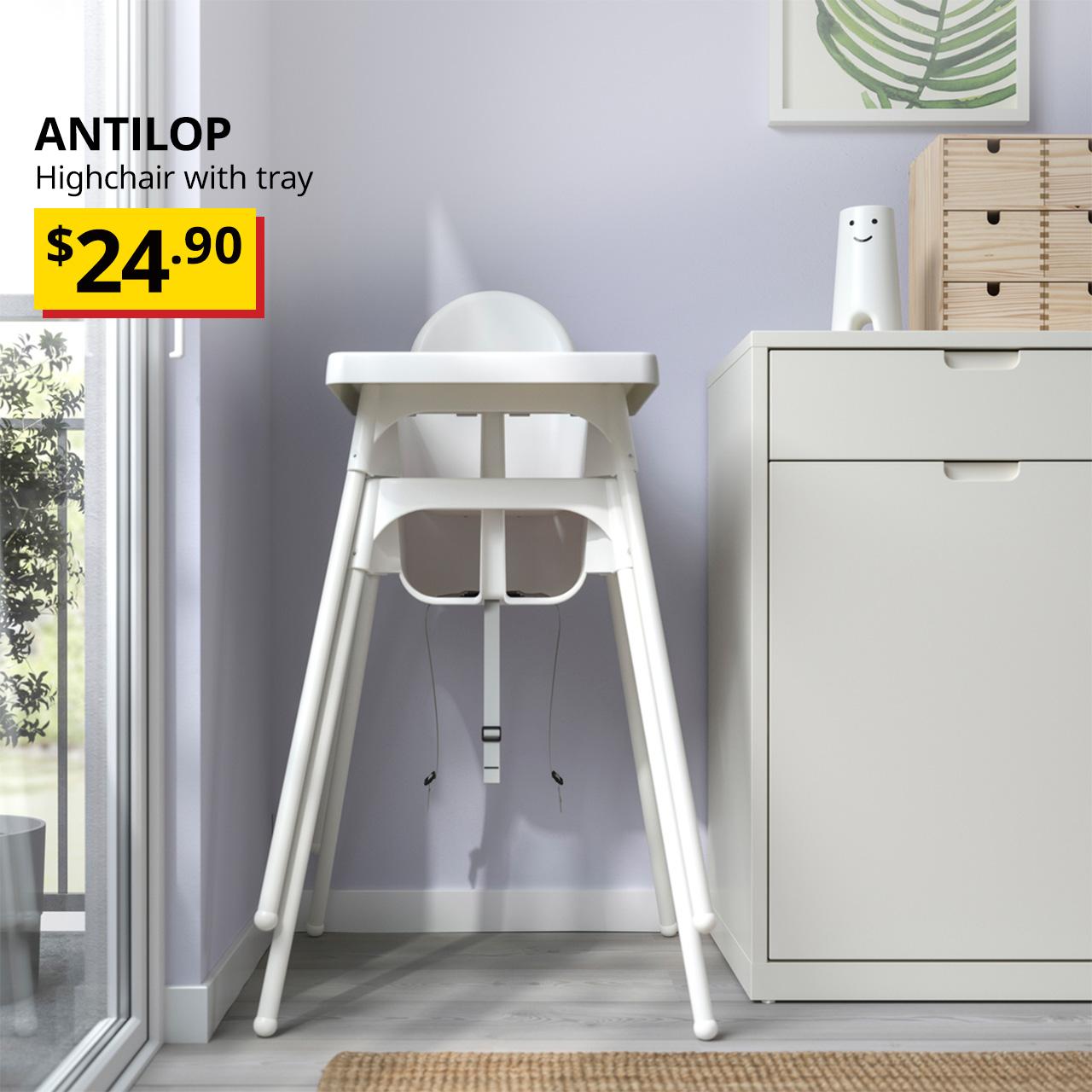 A white ANTILOP highchair with tray in a living room corner. Overlaid black text reads "ANTILOP, Highchair with tray" alongside a yellow and red "Breath-taking price" tag showing $24.90.