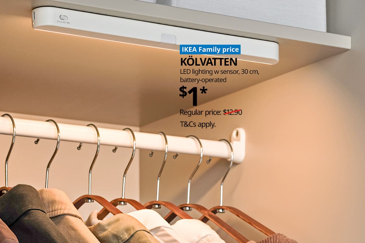 A white/battery-operated KÖLVATTEN LED lighting with sensor in a PAX wardrobe