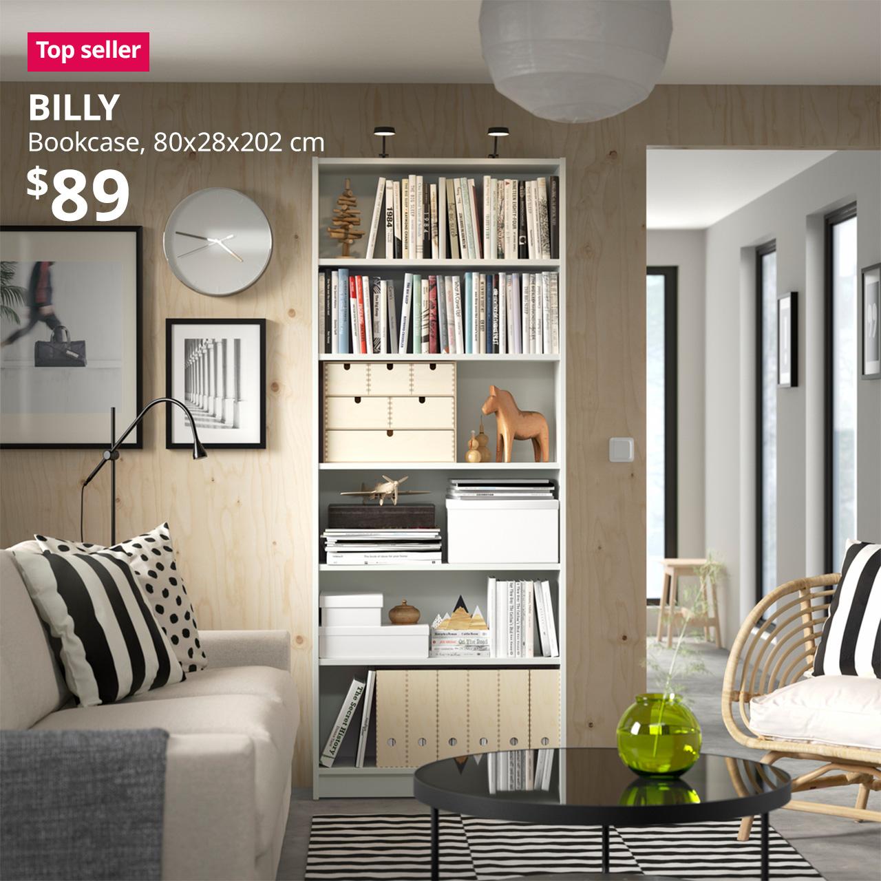 A white BILLY bookcase is being to display books and decorative items in a living room setting. A reddish pink "Top seller" tag is displayed on the top left corner of the image, followed by a white text overlay image that reads, "BILLY, Bookcase, 80x28x202 cm, $89"