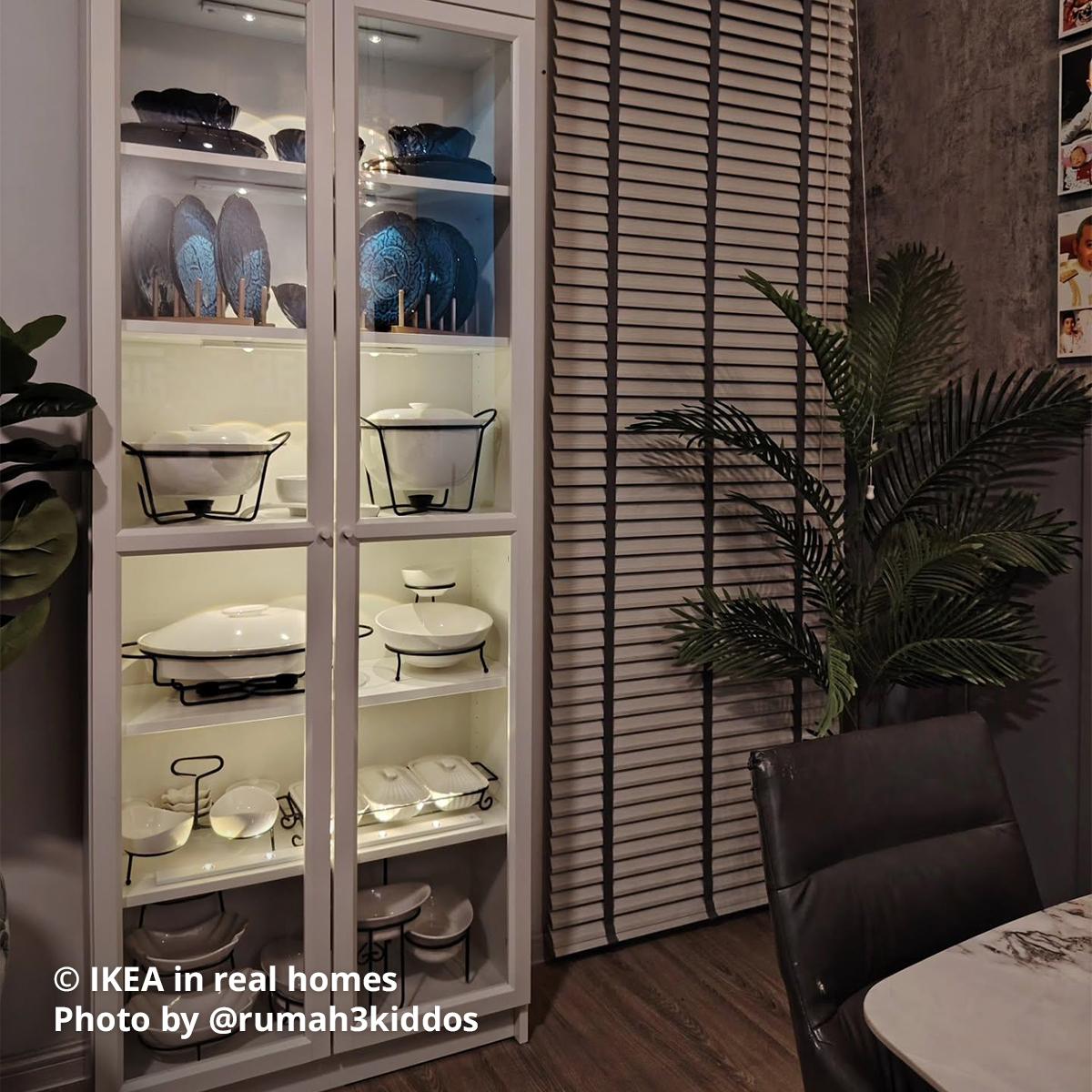 A white BILLY bookcase with cookware displayed with interior lighting placed at the dining area featuring IKEA in real homes Photo by @rumah3kiddos