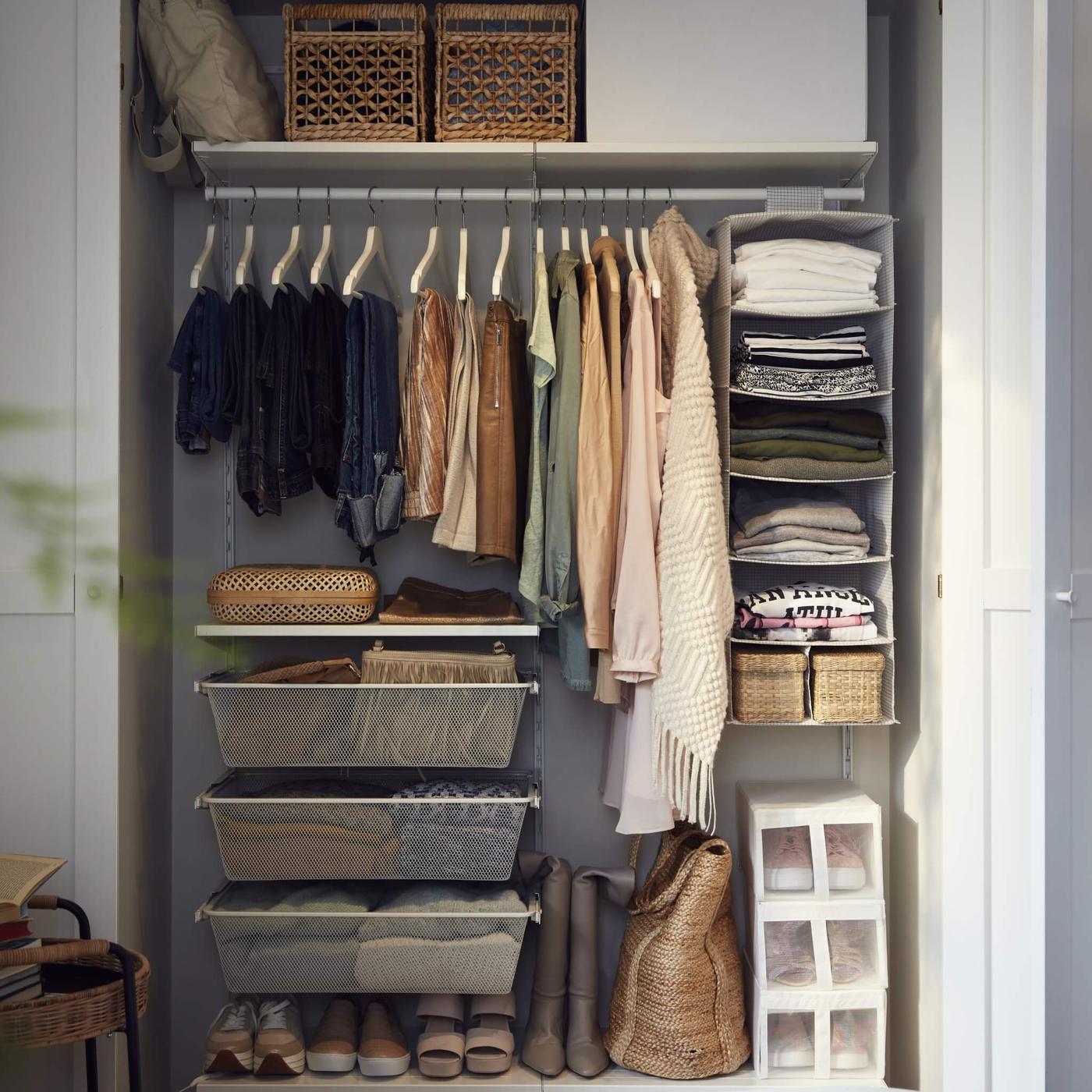 A white BOAXEL wardrobe combination with drawers and clothing rail and a 7-compartment STUK hanging organiser.