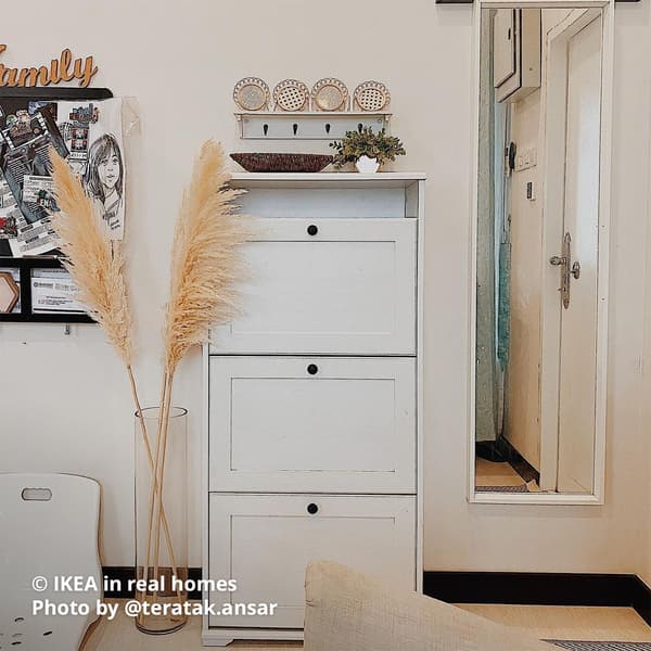 A white BRUSALI shoe cabinet with 3 compartment placed at the hallway as shoe storage.  IKEA in real homes Photo by @teratak.ansar.