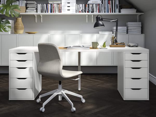 A white desk with MICKE storage drawers.