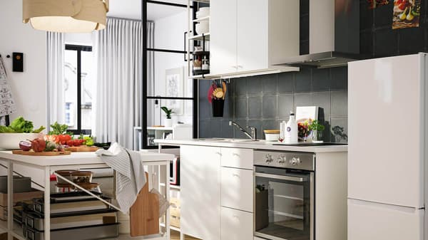 A white EHHET kitchen with vegetables on the countertop.