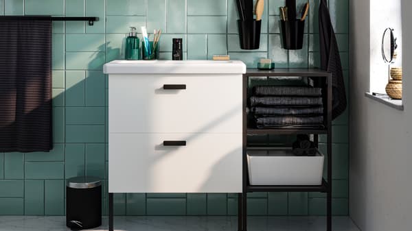 A white ENHET bathroom system in a green bathroom.