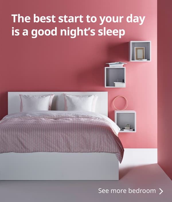 A white-framed bed in a bedroom with rose-coloured walls. Text reads: The best start to your day is a good night's sleep. See more bedroom >