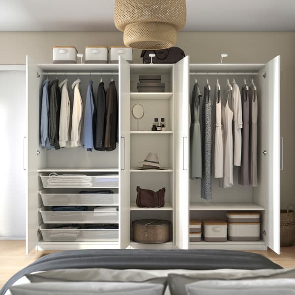 A white HAUGA wardrobe with sliding doors