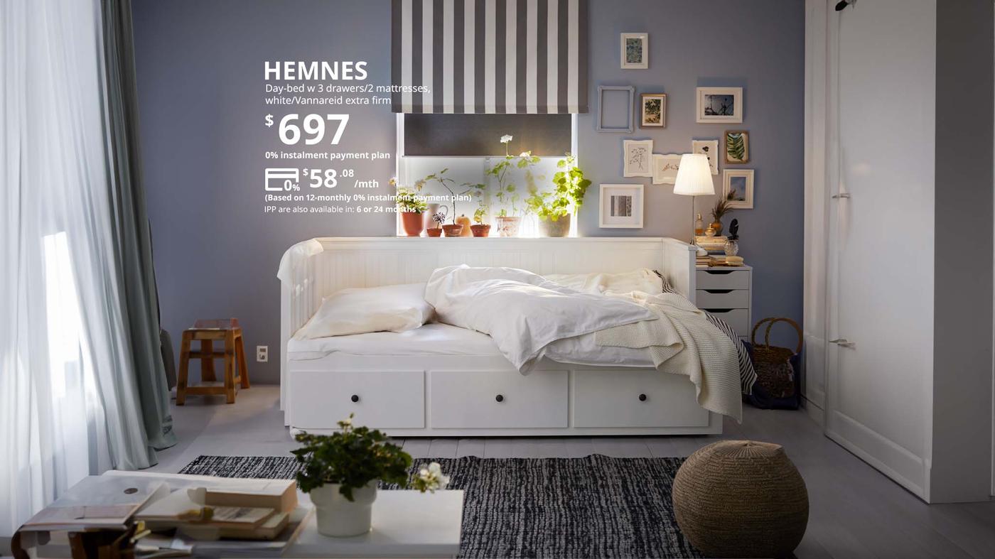 A white HEMNES day bed with 3 drawers and 2 mattresses, priced at $697 but now can be paid for $58.08 per month for 12 month
