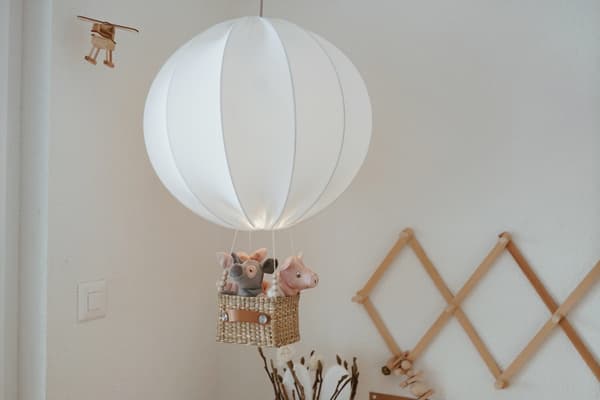 A white hot-air balloon with stuffed animals