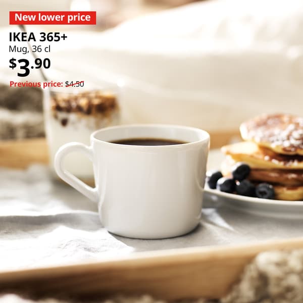 A white IKEA 365+mug on a breakfast tray. Text on image reads "New lower price, ikea 365+, Mug, 36 cl, $3.90, Previous price $4.50"