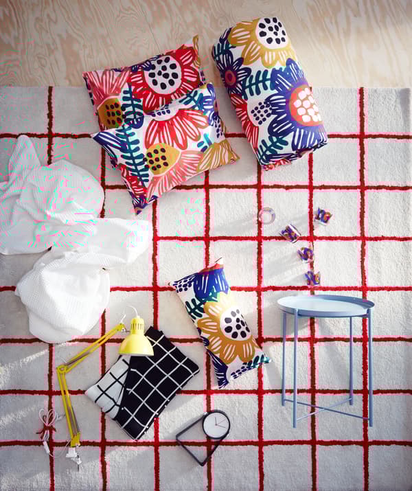 A white IKEA SIMESTED rug with a bright red square pattern and high pile is the backdrop for a product collage.