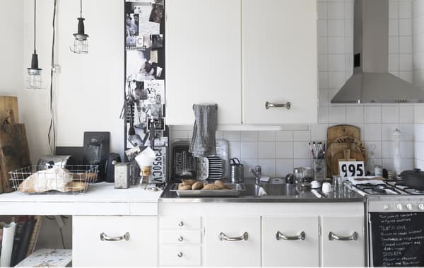 A white kitchen with metallic features.