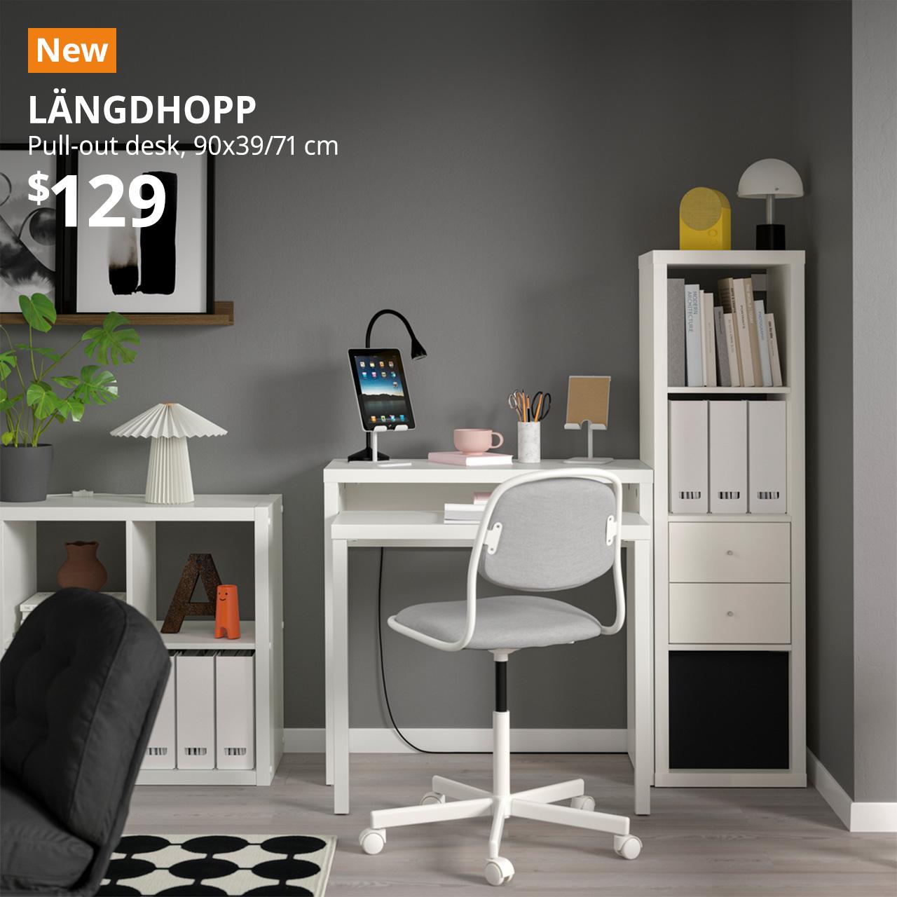 A white LÄNGDHOPP pull-out desk in the corner of a living room setting. On the top left corner, an orange tag with white text that reads, "New", followed by a white text overlay image that reads, "LÄNGDHOPP, Pull-out desk, 90x39x71 cm, $129".