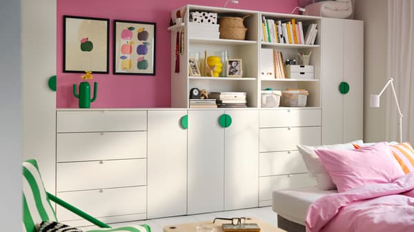 A white LASTARE wardrobe combination in a living room with pink walls.