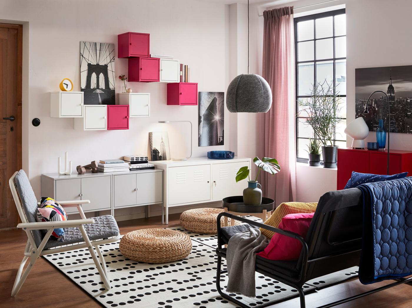 A white living room with free-standing and wall mounted LIXHULT cabinets in white, grey and pink against the back wall.