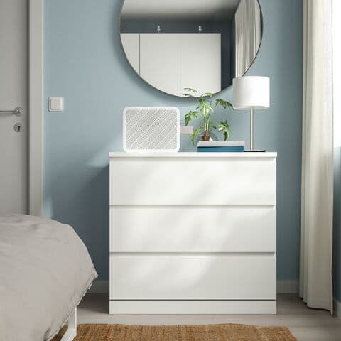 A white MALM drawer in a bedroom.