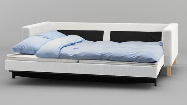 A white pull out sofa bed with a light blue blanket set against a gray background.