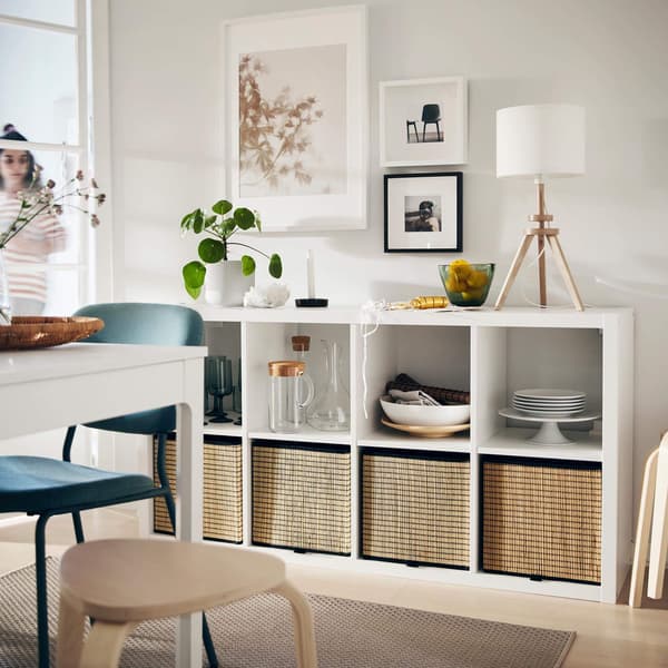 A white shelving unit with decor on it.