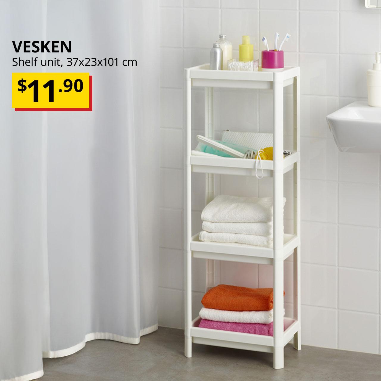 A white VESKEN shelf unit with bath towels and bathroom accessories is placed next to the bathroom sink in the bathroom setting. Text on image reads "VESKEN, Shelf unit, 37x23x101 cm, BTI Price: $11.90."