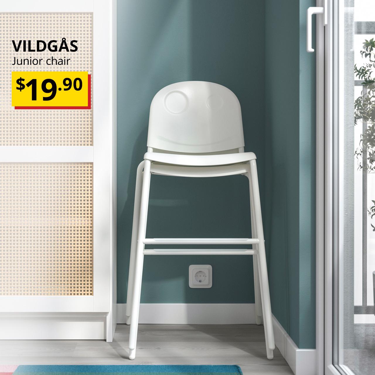 A white VILDGÅS junior chair stacked at the corner of the living room next to a white BILLY bookcase. Black text overlay image on the top left corner that reads, "VILDGÅS, Junior chair", with a breathtaking price tag in yellow/red of $19.90.