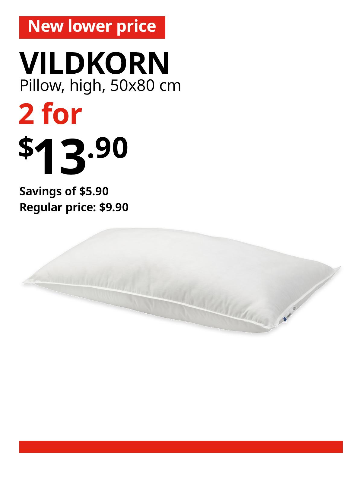 A white VILDKORN pillow. A red 'New lower price' tag, followed by black text that reads "VILDKORN, pillow, high, 50x80 cm" Multibuy deal of 2 for $13.90, with savings of $5.90. Regular price, $9.90.