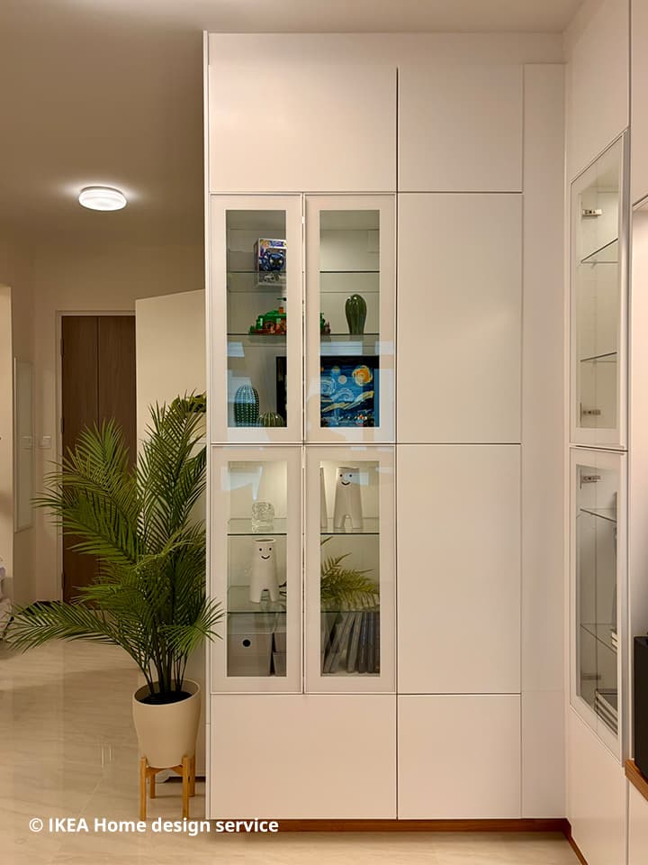 A wide shot of a BESTA display cabinet with glass panels from a traditional modern 4-room BTO flat in MacPherson, Singapore, designed by IKEA Home design service.